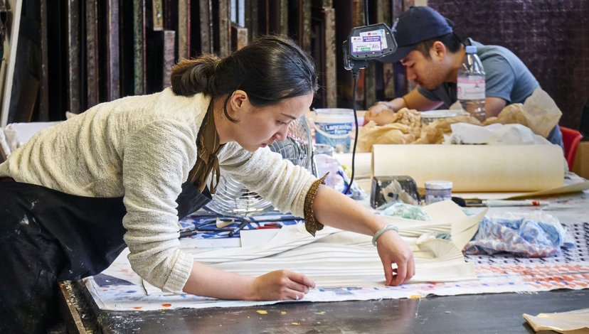 Two students working with fabric in the textiles dye lab