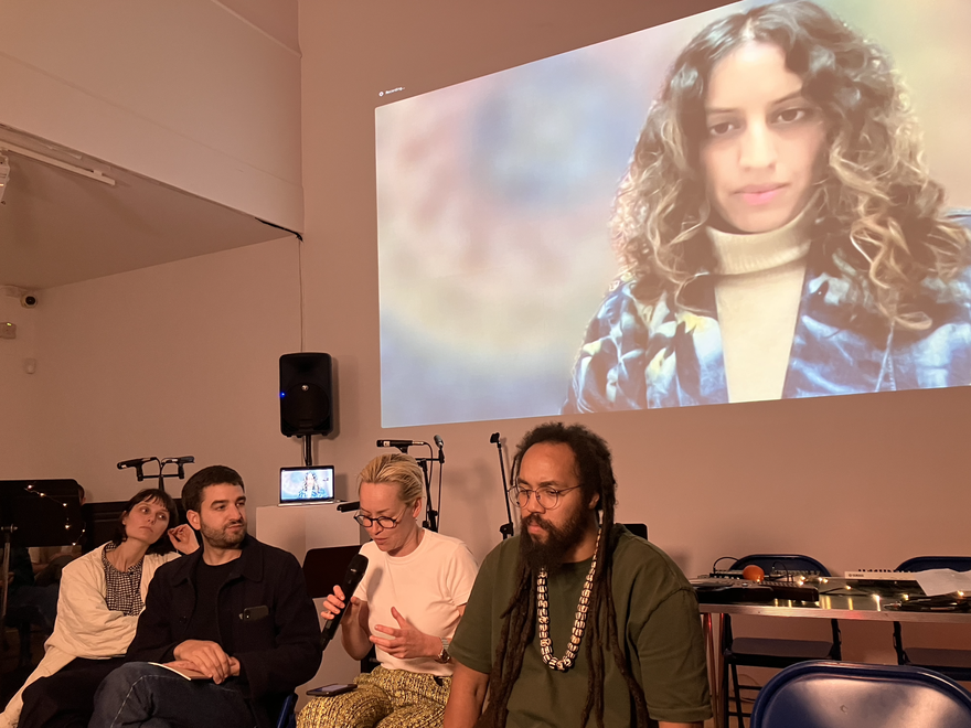 Dr Susannah Haslam convenes a panel talk in front of a projected image